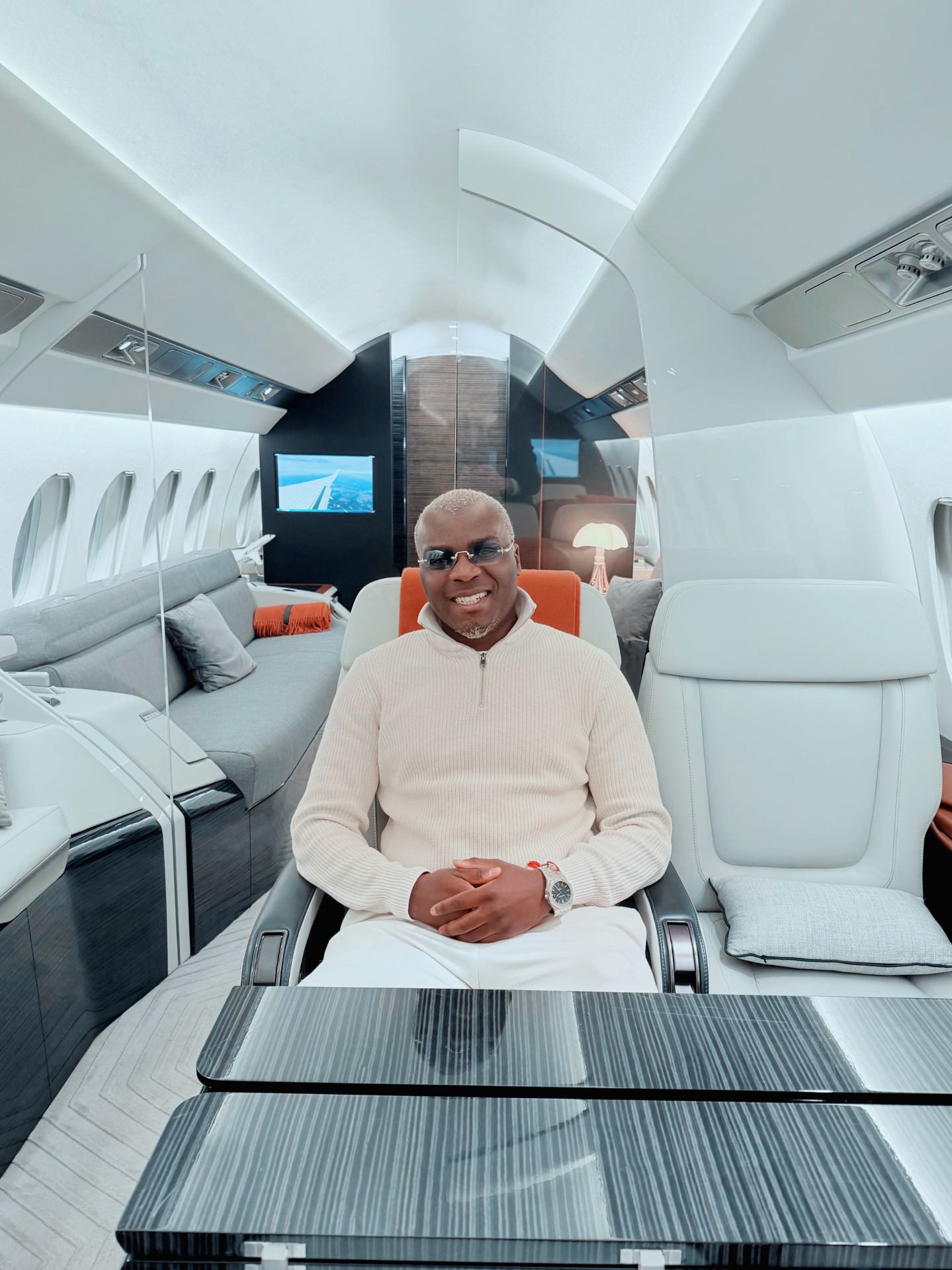 Lucien Ndabagera seated inside a private jet cabin