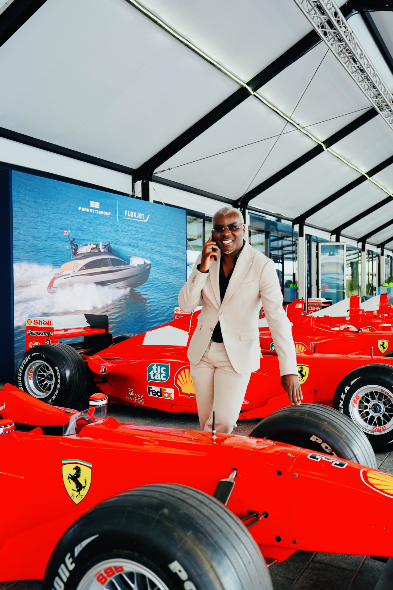 Lucien Ndabagera in front of Ferrari Formula 1 cars
